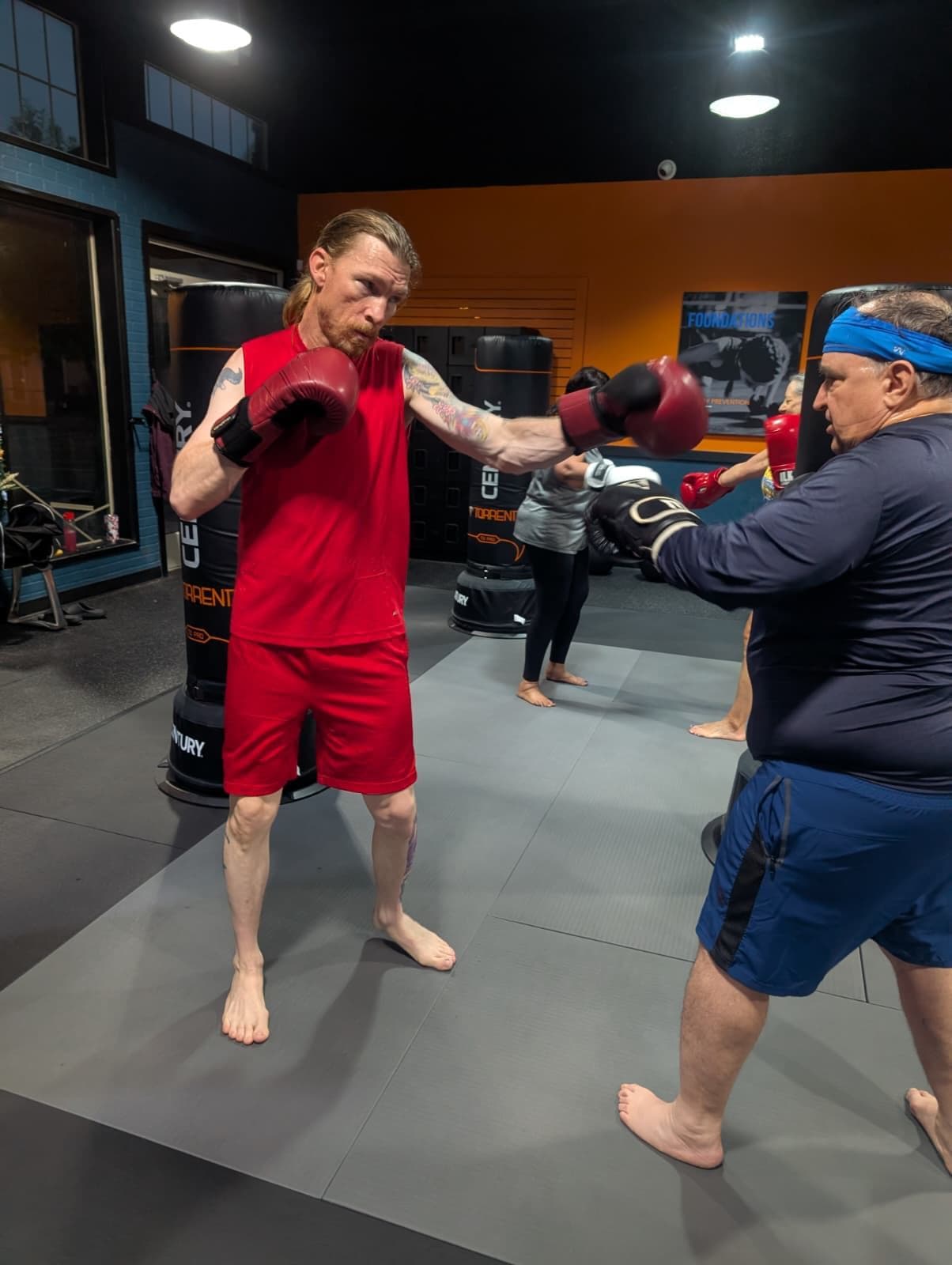 Vibes Lifestyle member throwing a punch during a coach-led kickboxing round