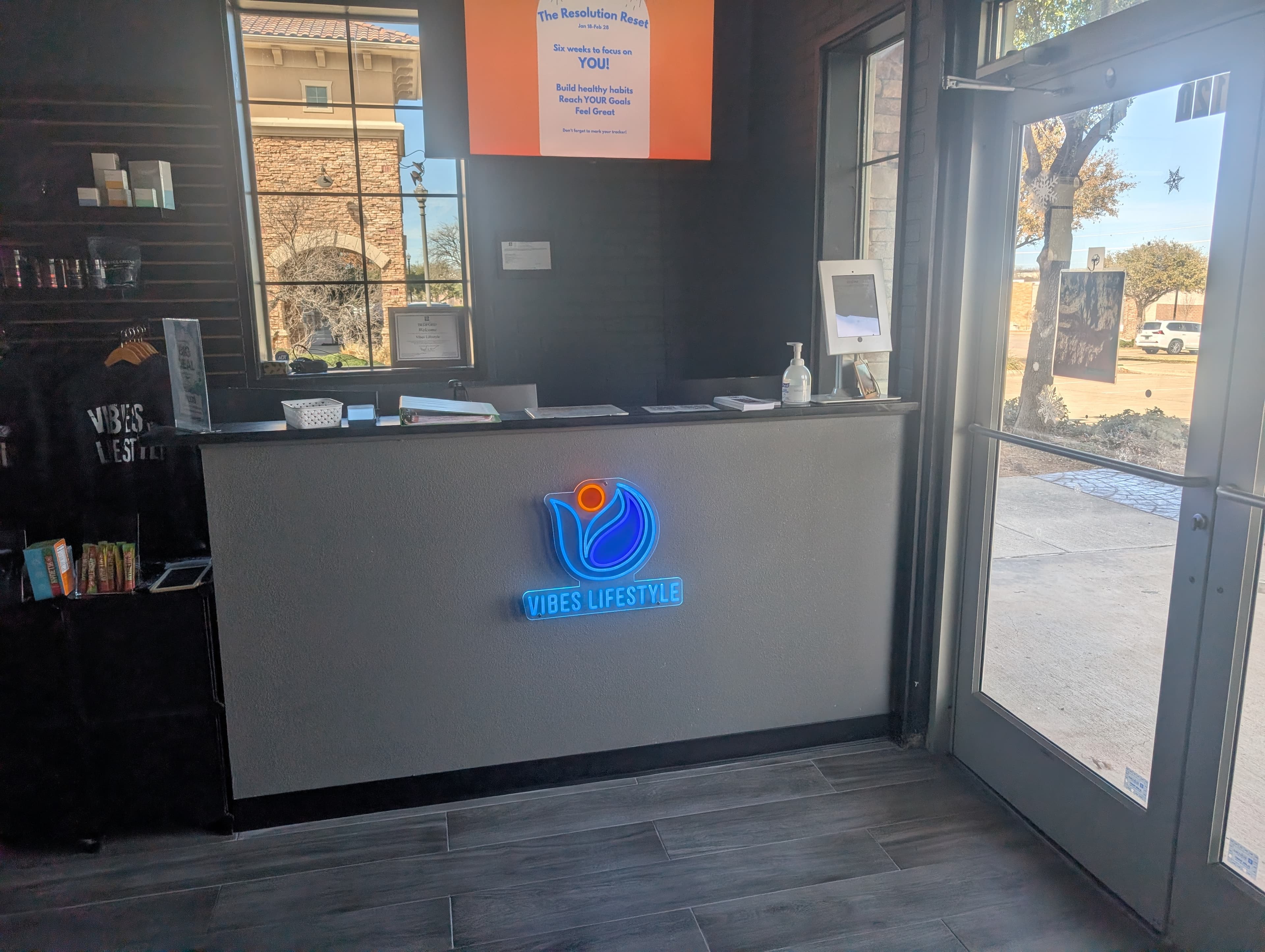 Vibes Lifestyle front desk with neon sign